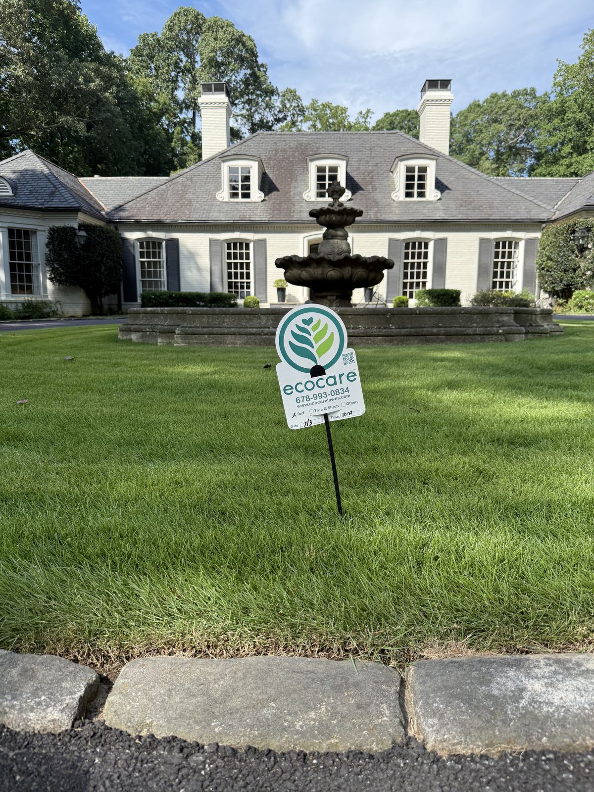 Ecocare yard sign on a large, healthy lawn