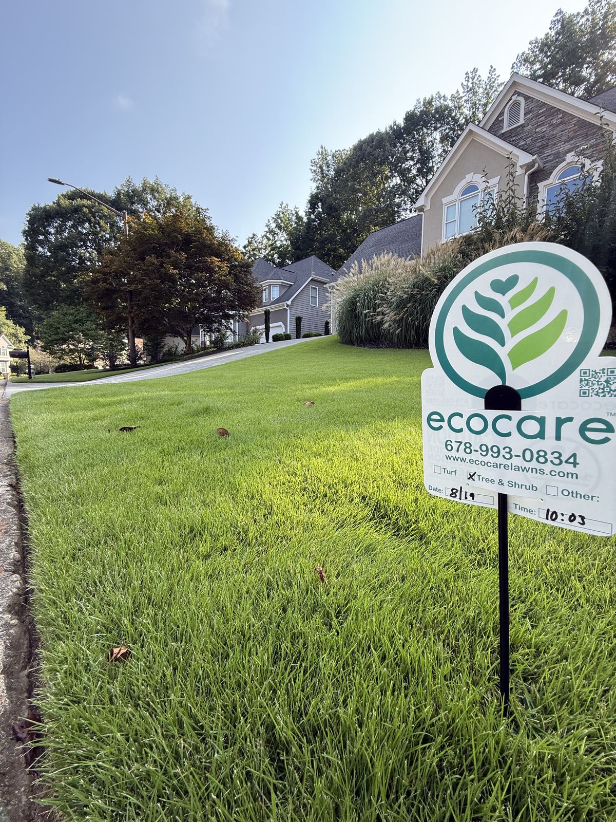 Ecocare yard sign on a thick green lawn